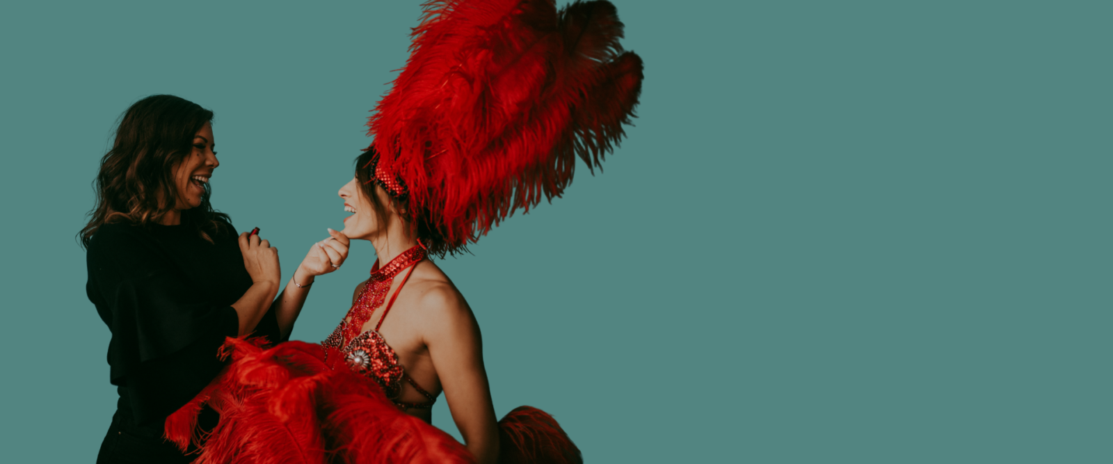 Nicole with performer in red feather headdress