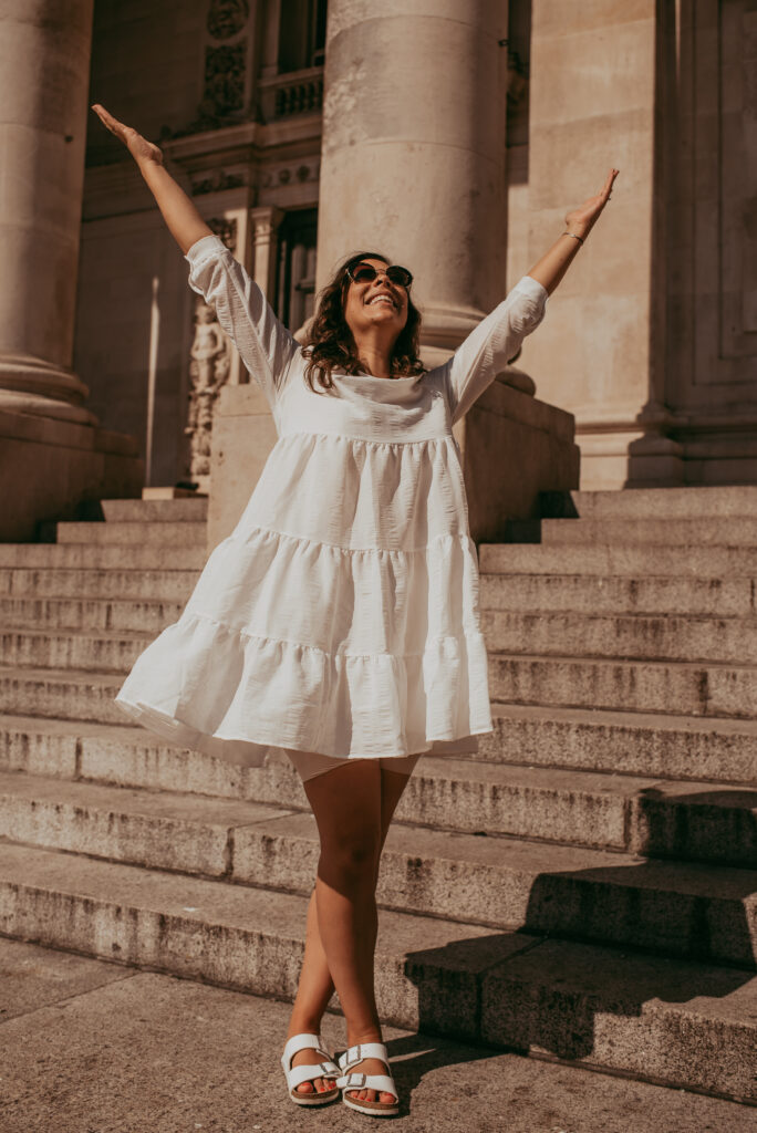 Nicole Geddes in White Dress with arms up